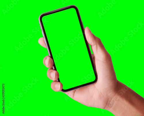 Studio shot of hand shows mobile smartphone with green screen in vertical position isolated on background. Mock up mobile for Infographic Global Business web site design app, - Clipping Path