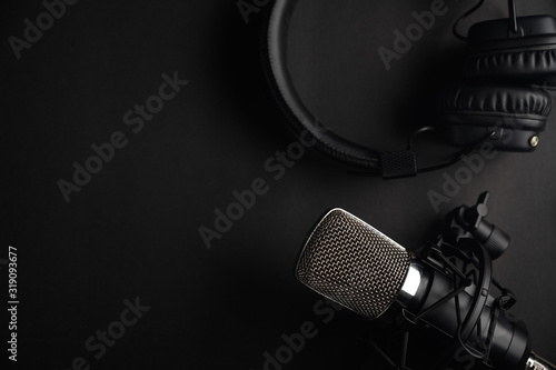 Podcasts and Stream. Flat lay. Studio condenser microphone black with professional headphones, top view with space for design.
