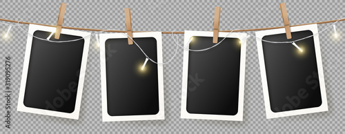 Realistic retro photo frames template. Vector illustration with blank photo cards with sparkling light garland hanging on rope. Mockup concept isolated on transparent background.