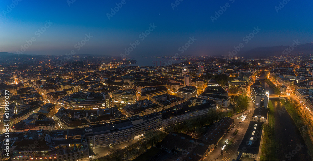 HIGH ANGLE VIEW OF ILLUMINATED BUILDINGS IN CITY AT NIGHT - obrazy, fototapety, plakaty 