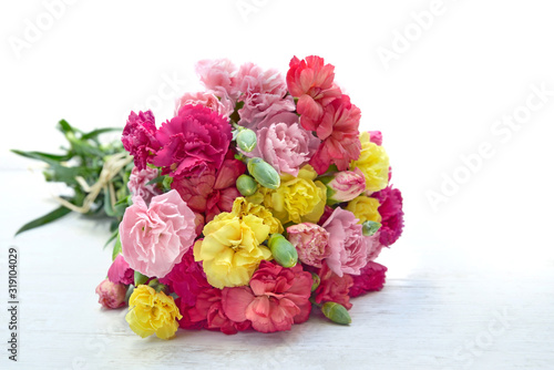 beautiful bouquet of colorful flowers carnation on a white table