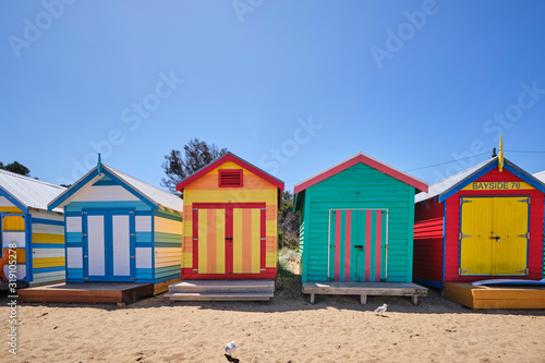 Brighton Beach huts/boxes on a blue sky sunny day with bright colours and textures © Orion Media Group