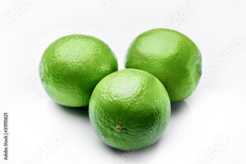 Three limes on a white background
