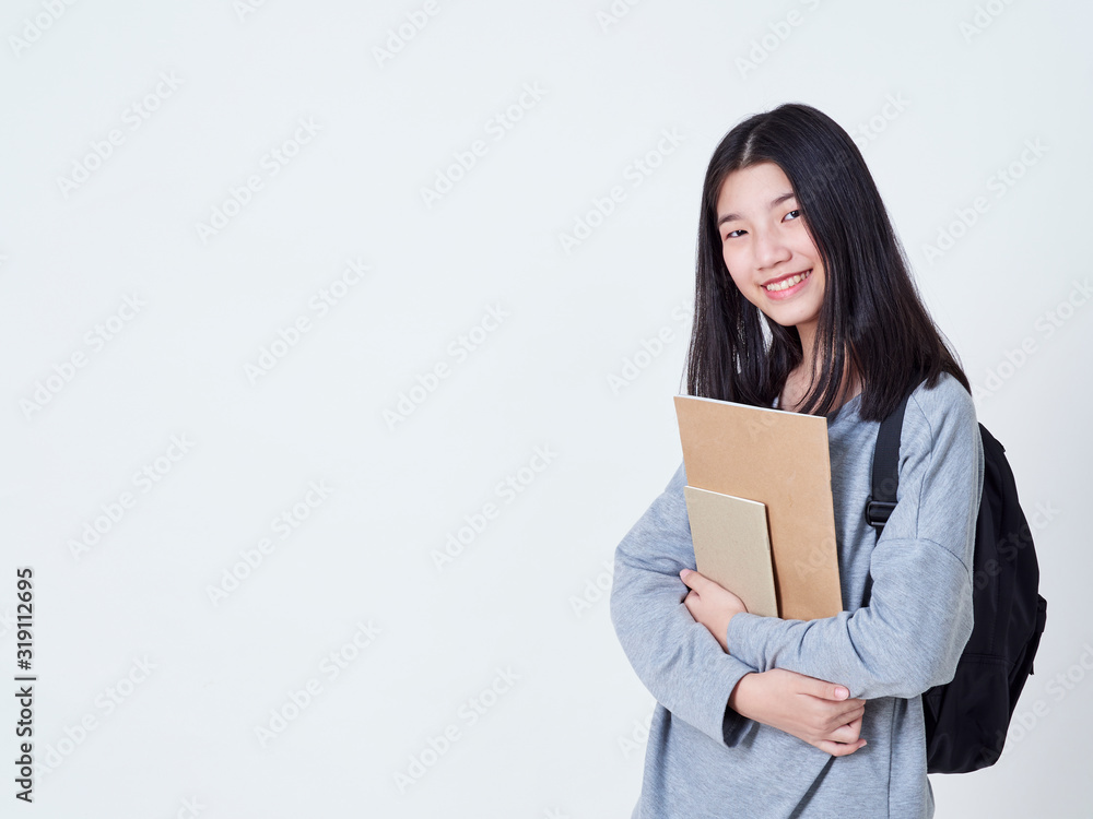 Girl student holding books with backpacks. Girl student holding books with backpacks.