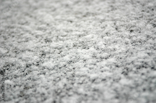 Fresh snow on a flat stone surface