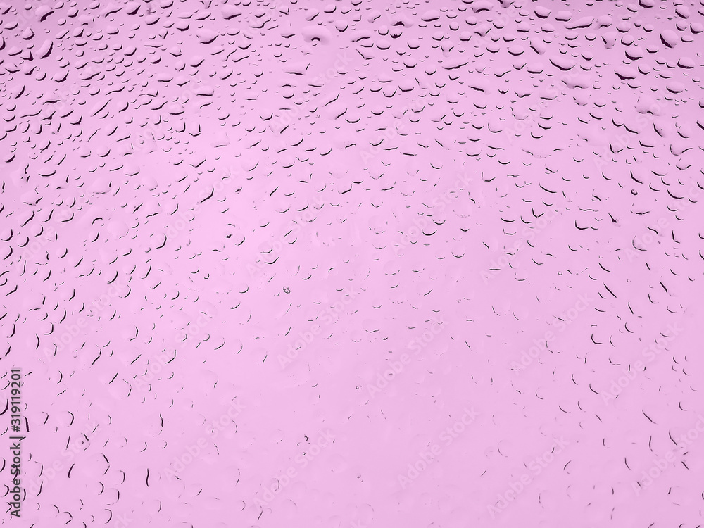 Water drops on pink background, abstract shot of raindrops on glass Water drops on pink background, abstract shot of raindrops on glass