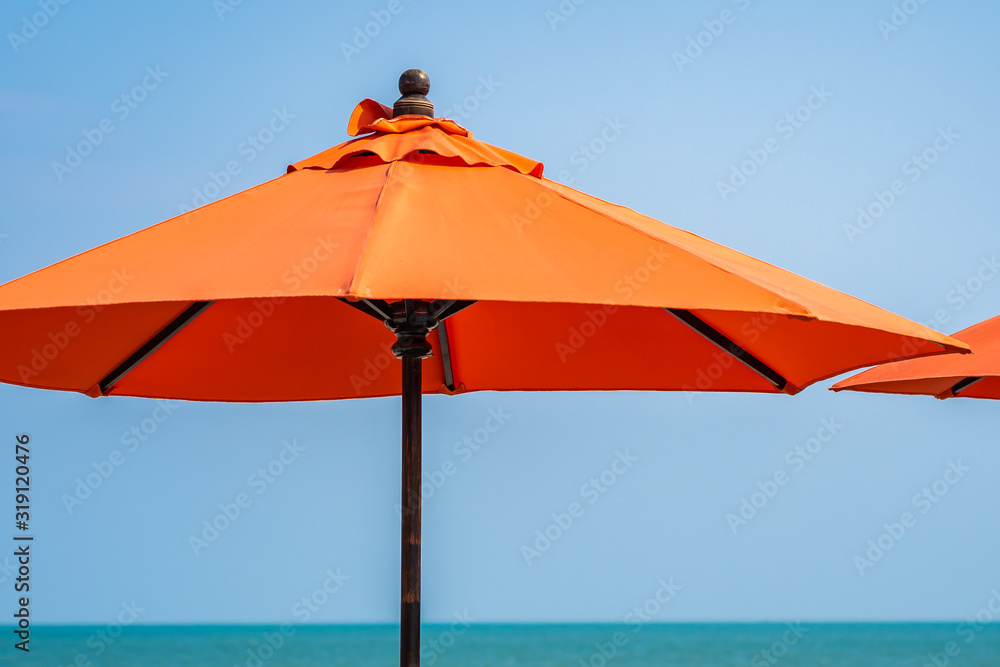 Umbrella with beautiful blue sky background nearly sea ocean beach