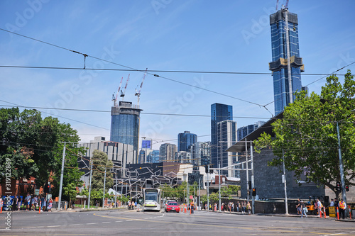 Melbourne city scene with buildings, tram on blue sky sunny day photo