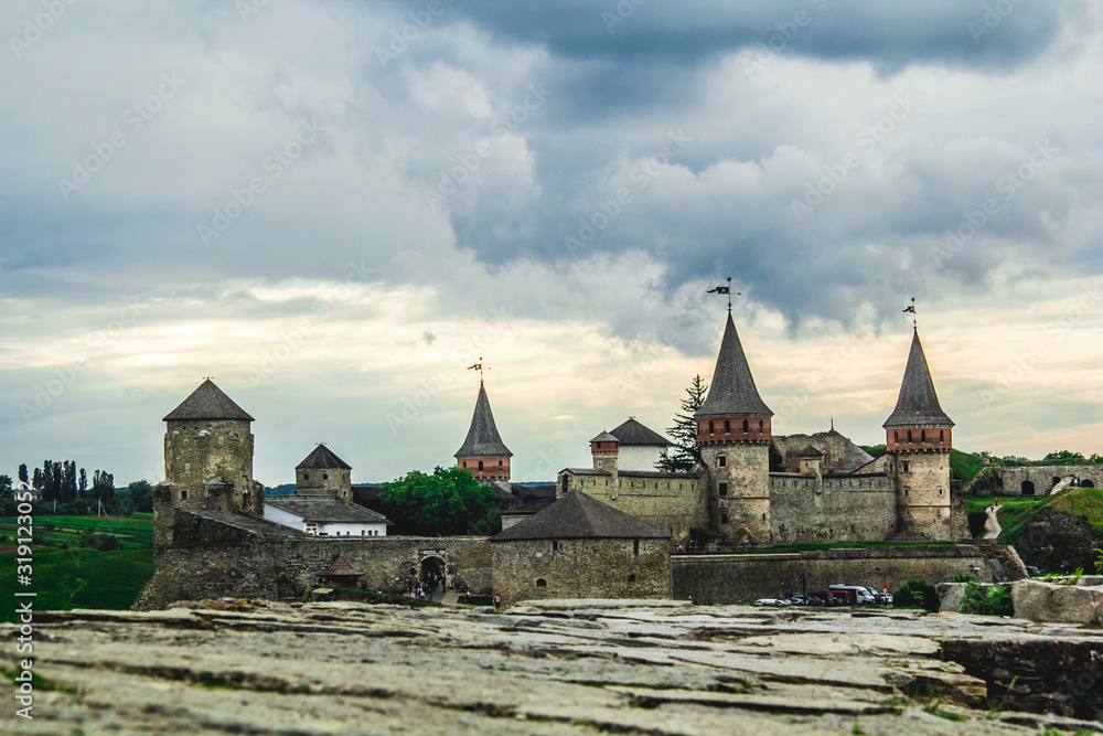 Photo of ancient stone castle with many hight towers in Kamyanets-Podilsky
