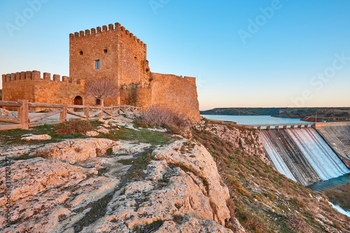 Stone castle and dam in Spain. Penarroya fortification, Castilla Mancha. photo