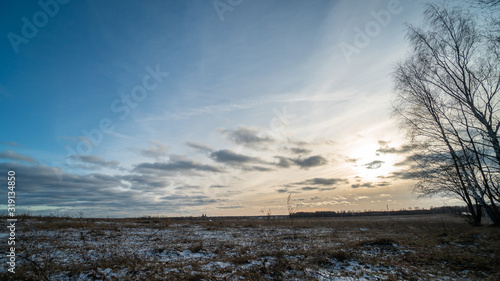 Beautiful setting sun over frozen field