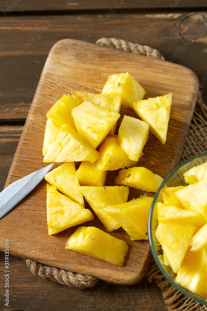 fresh pineapple pieces on wooden surface fresh pineapple pieces on wooden surface