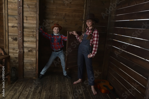 brother and sister in cowboy hats photo