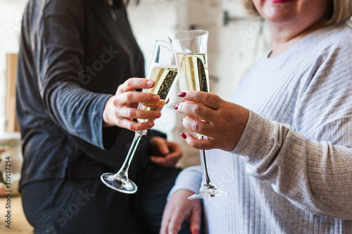 People's hands with glasses of champagne, celebrating a holiday, salute, holiday and birthday