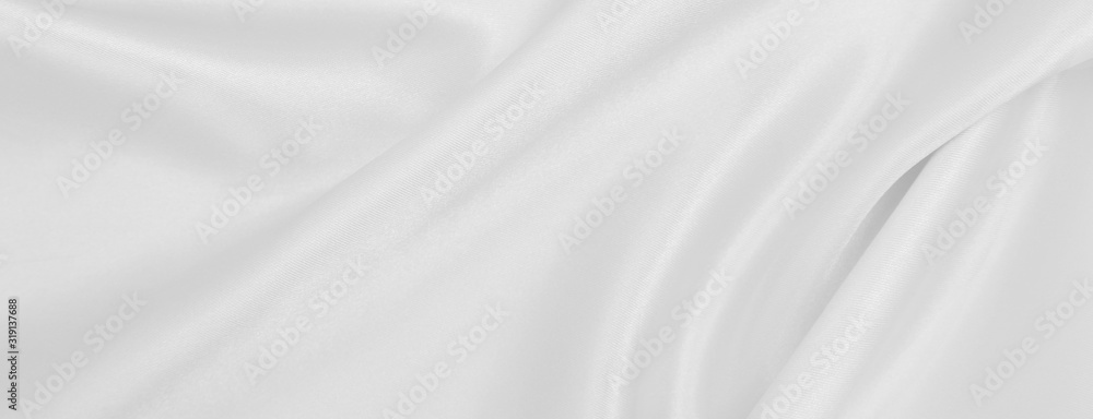 Smooth elegant white silk or satin luxury cloth texture as wedding background. Luxurious background design