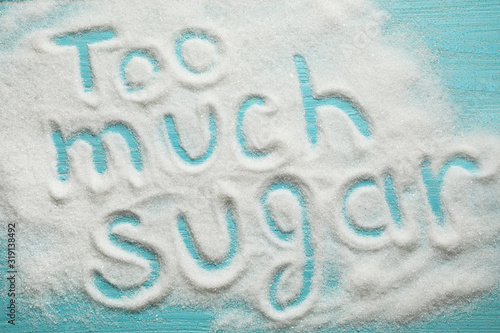 Flat lay composition with phrase TOO MUCH SUGAR on blue wooden table