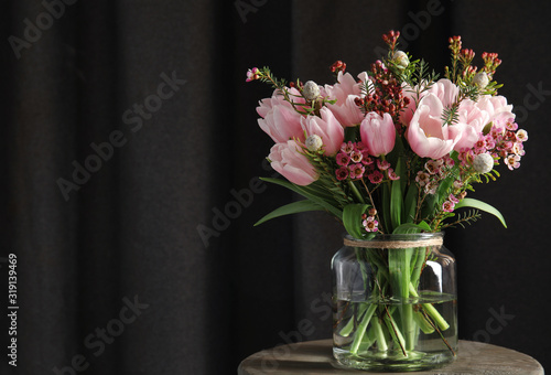 Fototapeta Naklejka Na Ścianę i Meble -  Beautiful bouquet with spring pink tulips on wooden table. Space for text
