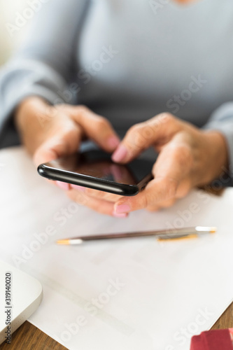 businesswoman typing a message on her mobile phone