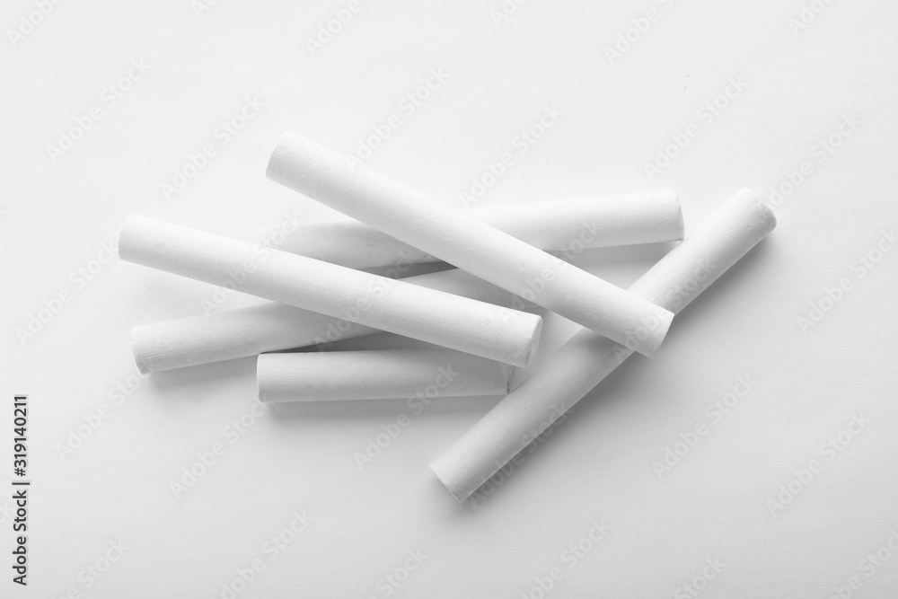 Pieces of chalk on white background, top view Pieces of chalk on white background, top view