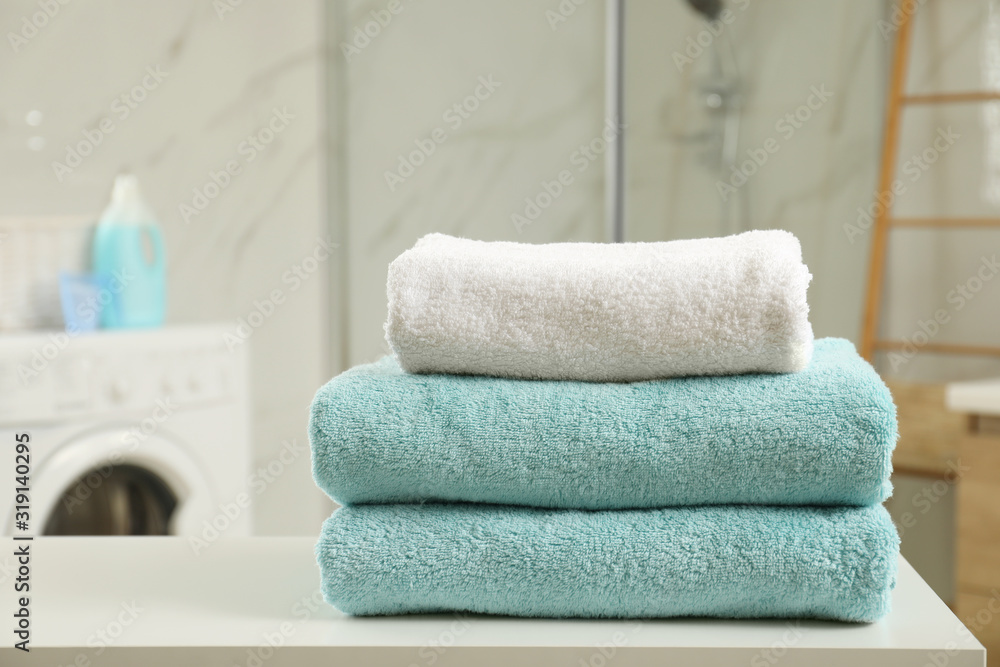 Stack of clean towels on table in laundry room Stack of clean towels on table in laundry room