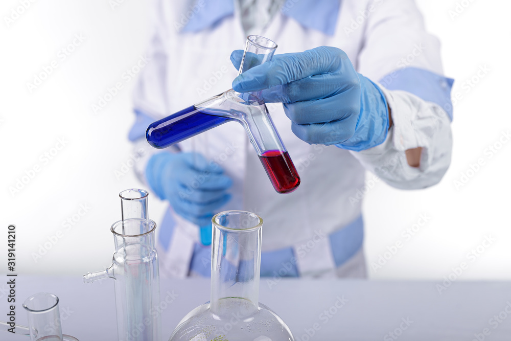 chemist mixes two liquids, photo on a light background chemist mixes two liquids, photo on a light background