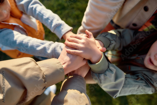 We are stronger together. Family holding hands together closeup