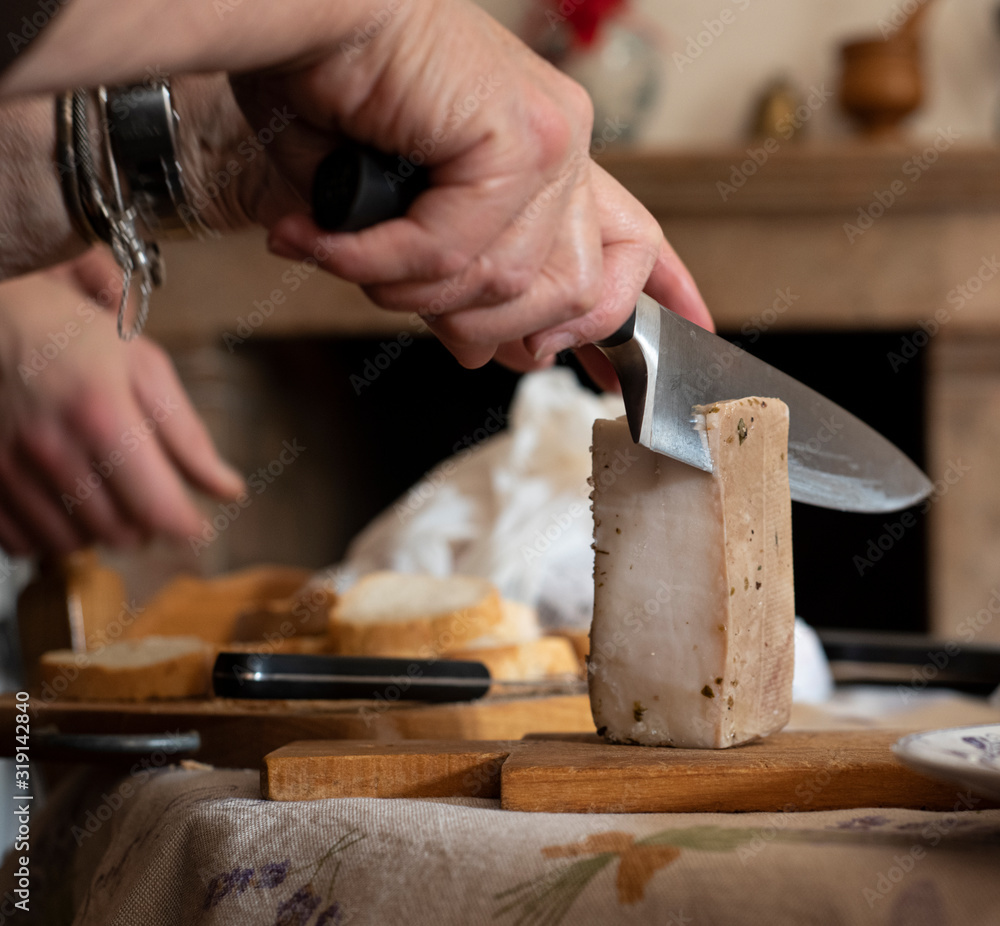 Man slicing a block of lard with a chefs knife Man slicing a block of lard with a chefs knife