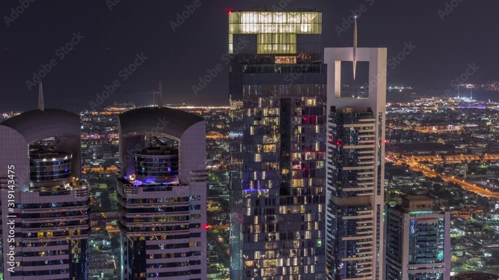 Skyline of the buildings near Sheikh Zayed Road and DIFC aerial night timelapse in Dubai, UAE. Modern towers and illuminated skyscrapers in financial center and downtown Skyline of the buildings near Sheikh Zayed Road and DIFC aerial night timelapse in Dubai, UAE. Modern towers and illuminated skyscrapers in financial center and downtown