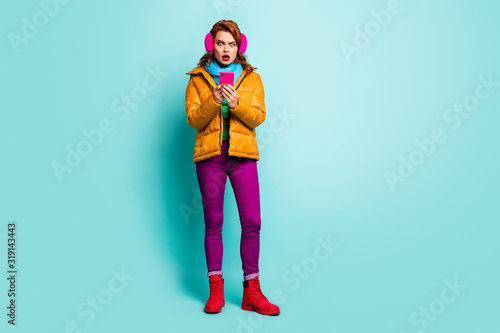 Oh no. Full size photo of traveler lady hold telephone open mouth read bad news wear trendy casual yellow overcoat scarf purple pants shoes isolated teal color background