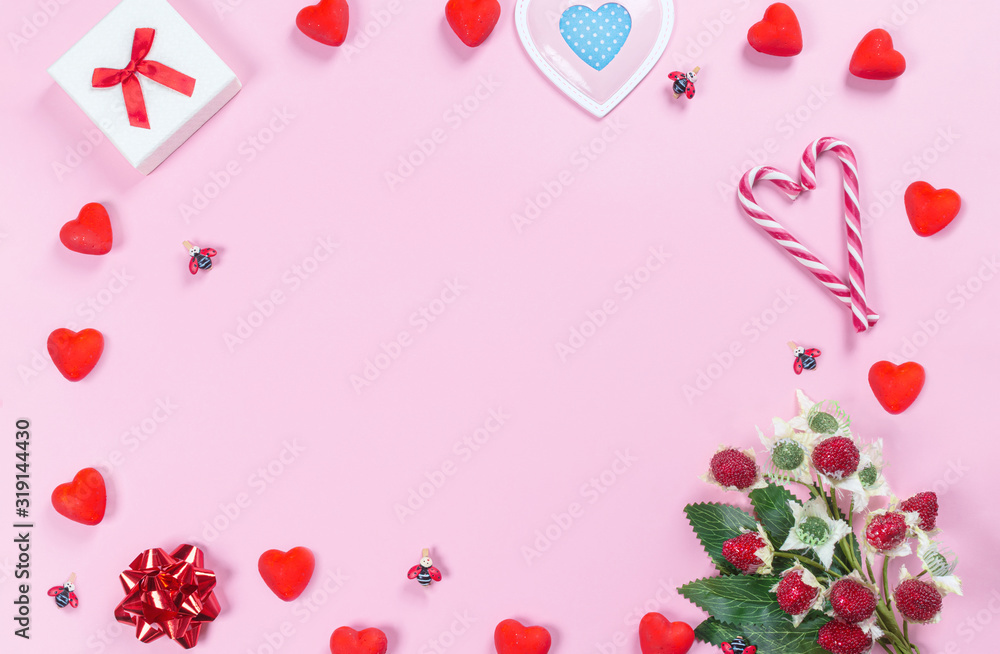 Composition of red hearts, berries and toys for Valentine's day on a pink background. Text frame. Flat lay, top view-greeting card template. Copyspace. Mockup.