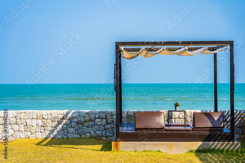 Pillow on sofa bed with lounge around beach ocean sea and blue sky