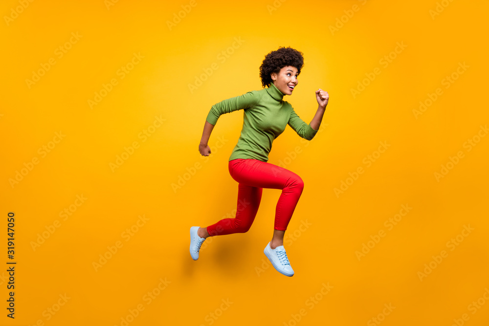 Full length body size view of her she nice attractive lovely girlish cheerful cheery wavy-haired girl jumping running activity isolated over bright vivid shine vibrant yellow color background