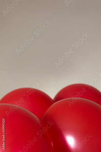 red helium balloons on beige background