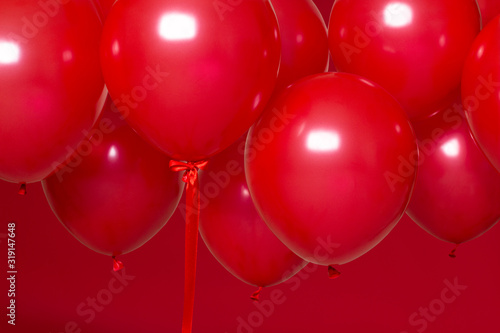 red helium balloons on red background