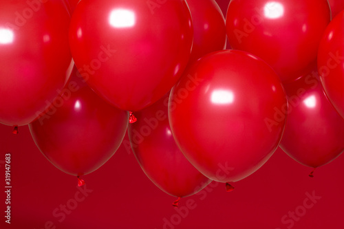 red helium balloons on red background