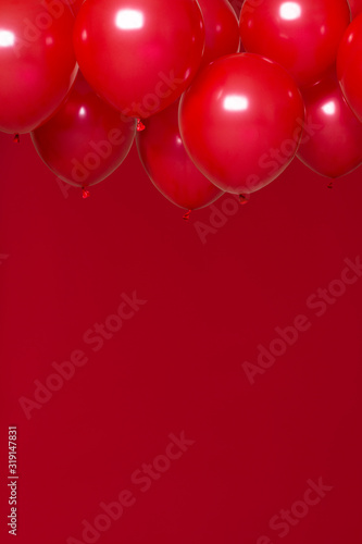 red helium balloons on red background