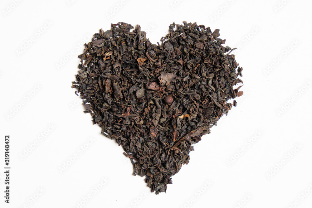 An abstract heart of black tea on a white background. Isolated. An abstract heart of black tea on a white background. Isolated.