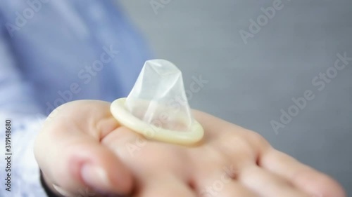 Man takes a condom from a woman on a white background