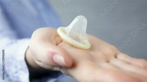 Man takes a condom from a woman on a white background