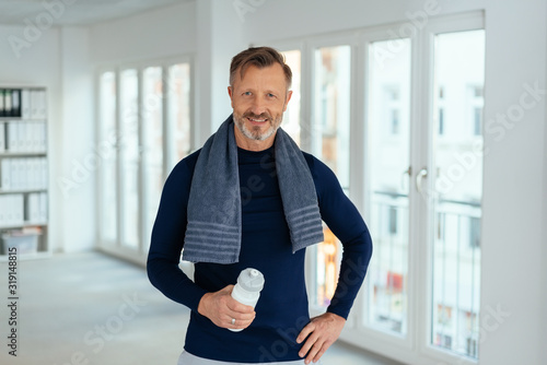 Fototapeta Naklejka Na Ścianę i Meble -  Smiling friendly athletic middle-aged man