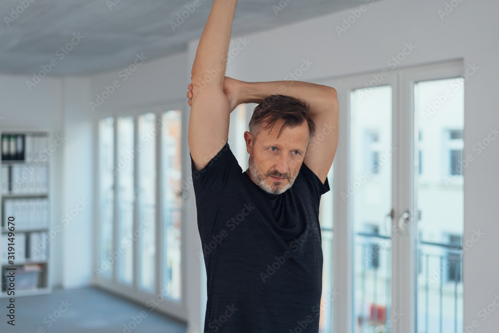 Man doing arm stretching exercises Man doing arm stretching exercises