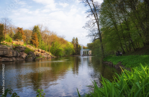 Beautiful view of the pond with the fountain Snake and the pavilion Flora in the National Dendrological Park Sofiyivka, Uman, Ukraine