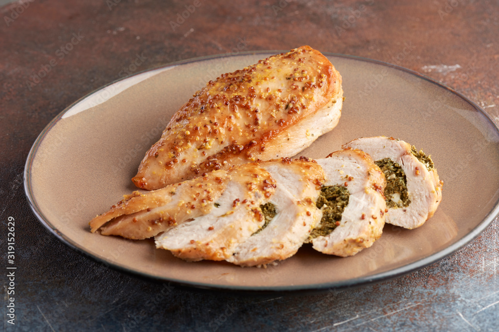 chicken breast stuffed with spinach on a grey plate on a grey background chicken breast stuffed with spinach on a grey plate on a grey background