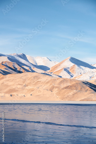 White and yellow sandy mountain with snow covered located in Xinjiang China Tashkurgan(Taxkorgan).