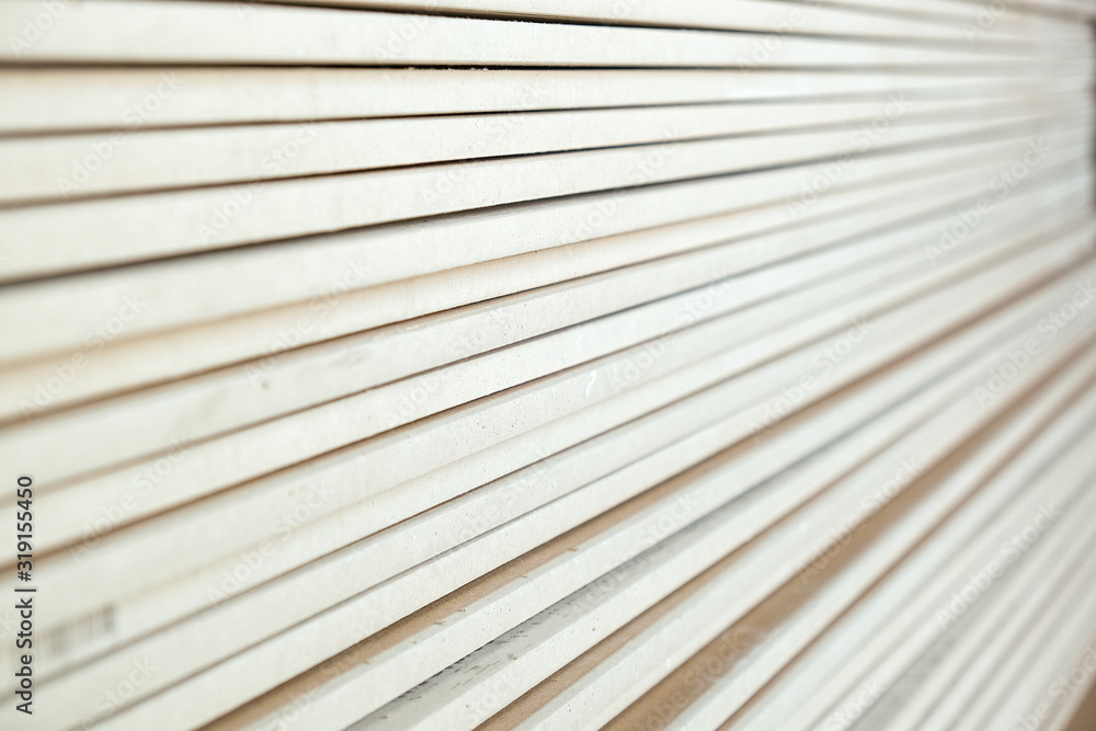 photo of a stack of drywall from close range photo of a stack of drywall from close range