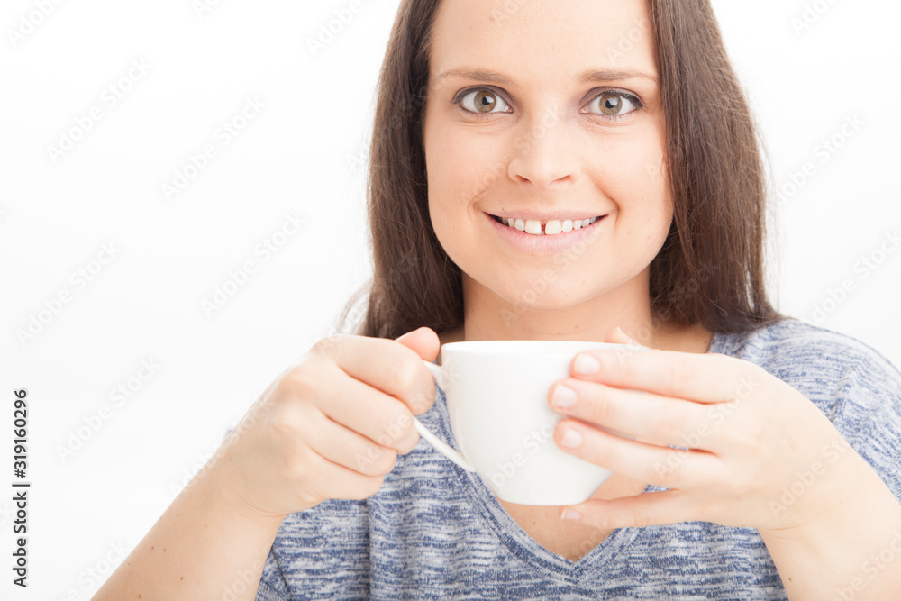 Female holding and drinking cup of warm tea of coffee, wearing blue on white background Female holding and drinking cup of warm tea of coffee, wearing blue on white background