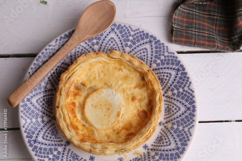 Delicious three cheese quiche in colored background