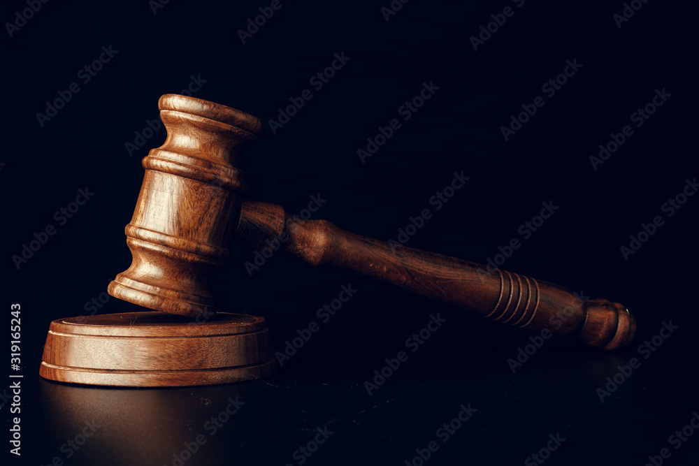Judge gavel close up on paper background. Law and justice, legality concept Judge gavel close up on paper background. Law and justice, legality concept