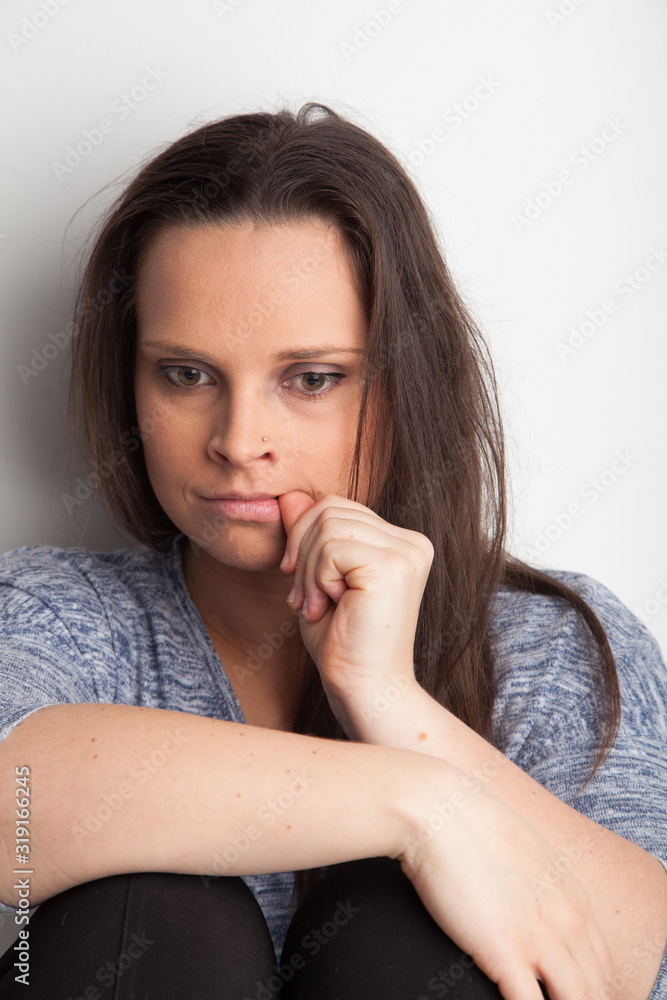 Female biting finger nails, feeling anxious. Female biting finger nails, feeling anxious.
