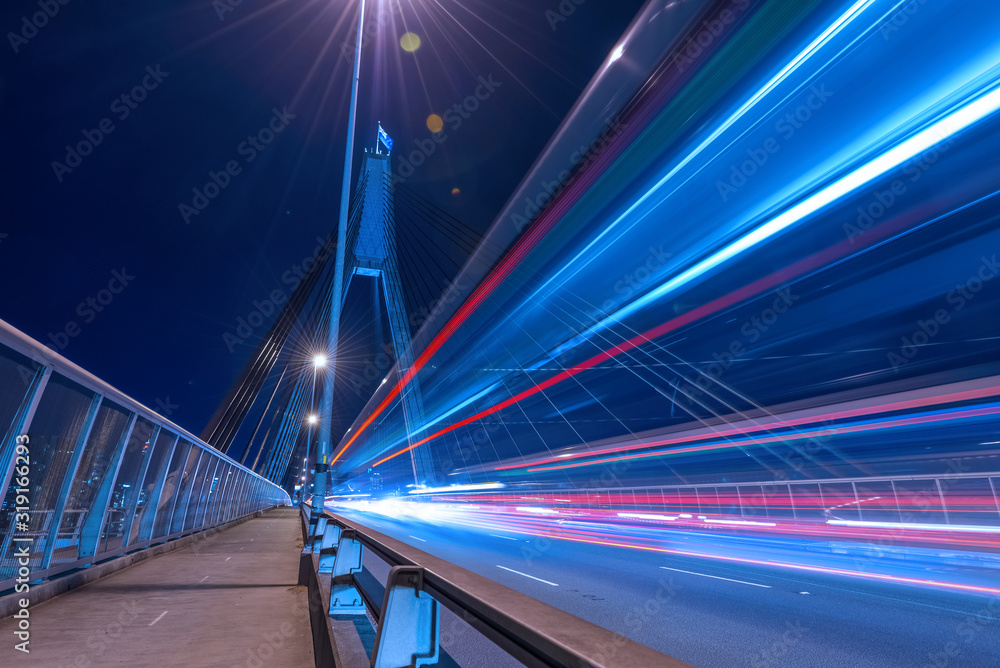 Long exposure picture of a night traffic through the Anzac Bridge in Sydney